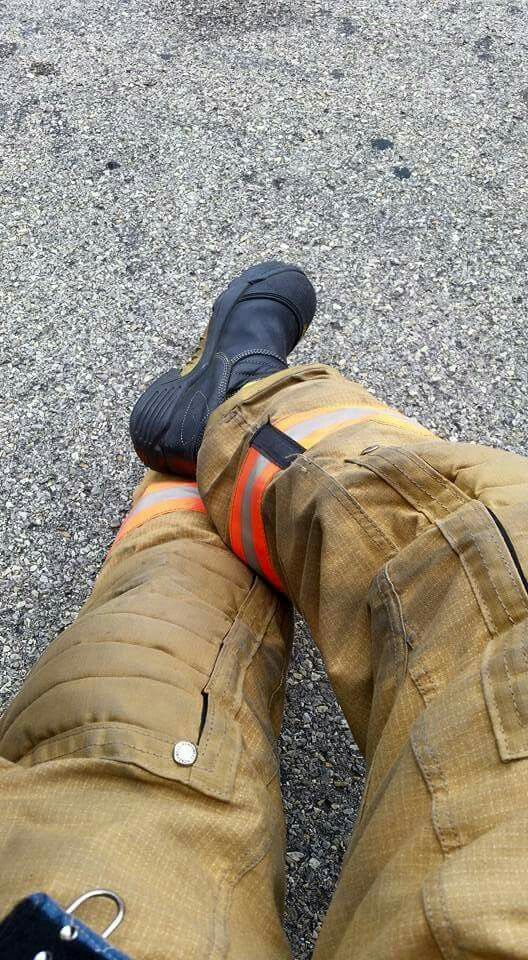 the legs and feet of a fireman in orange pants