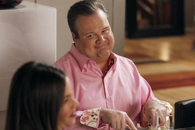 a man and woman sitting at a table eating food