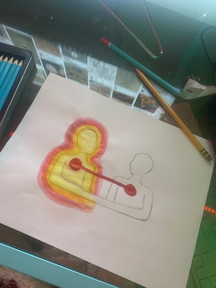 a child's drawing on paper with colored pencils