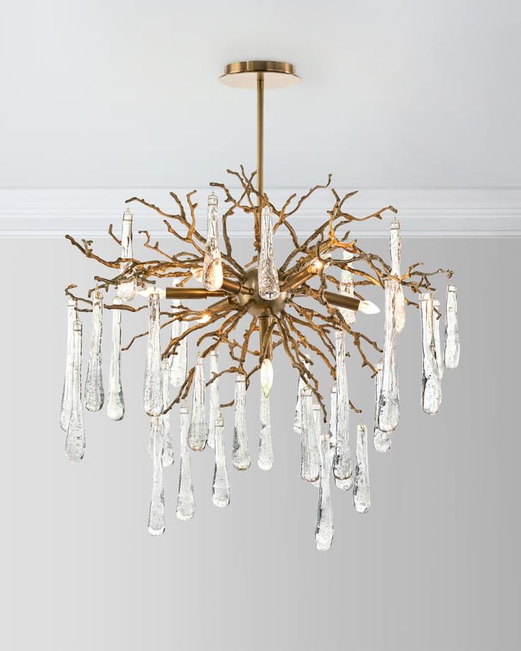 a chandelier hanging from the ceiling in a room with white walls and flooring