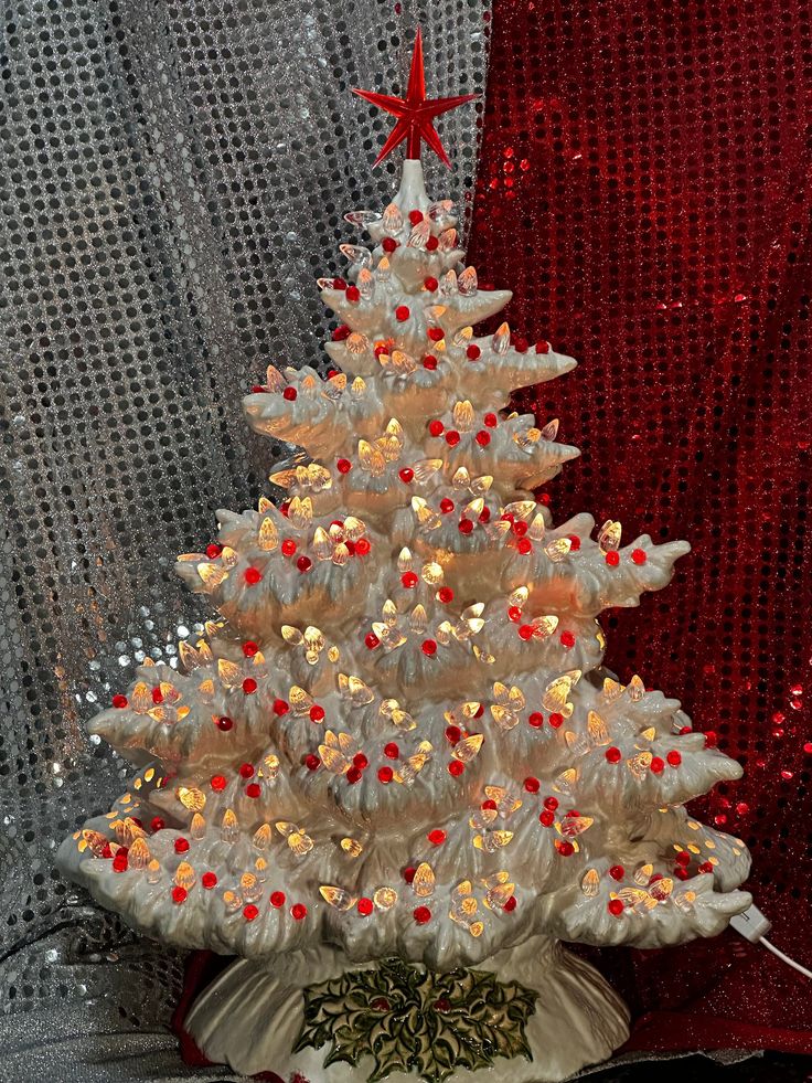 a white christmas tree with red and yellow lights