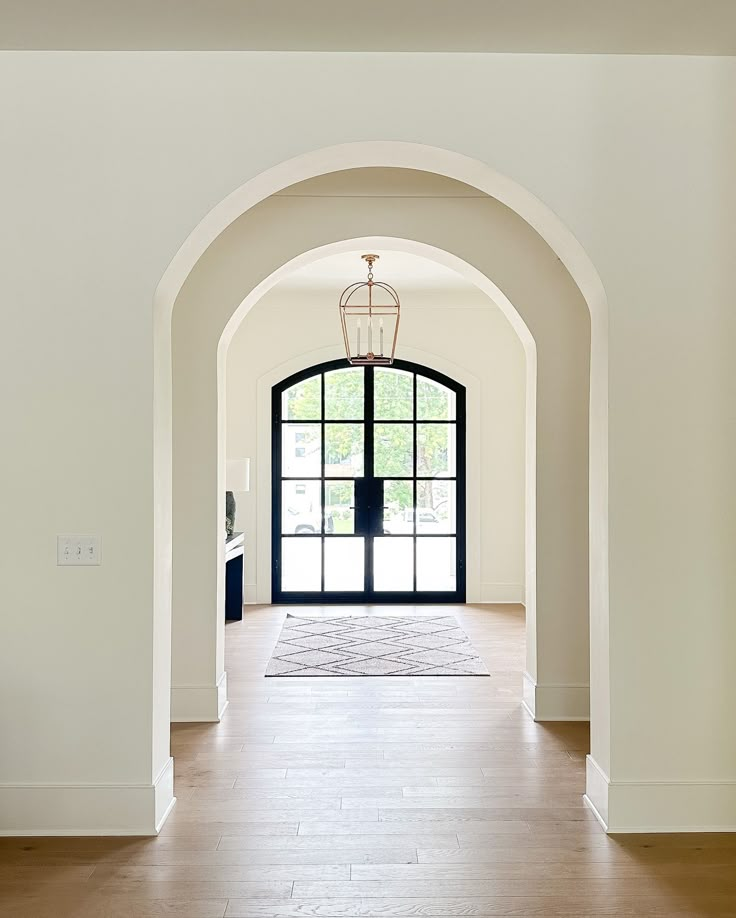 an archway leading into a large white room