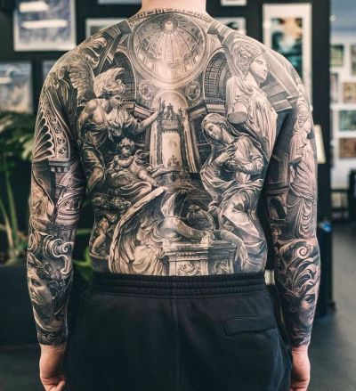 the back of a man with tattoos on his body