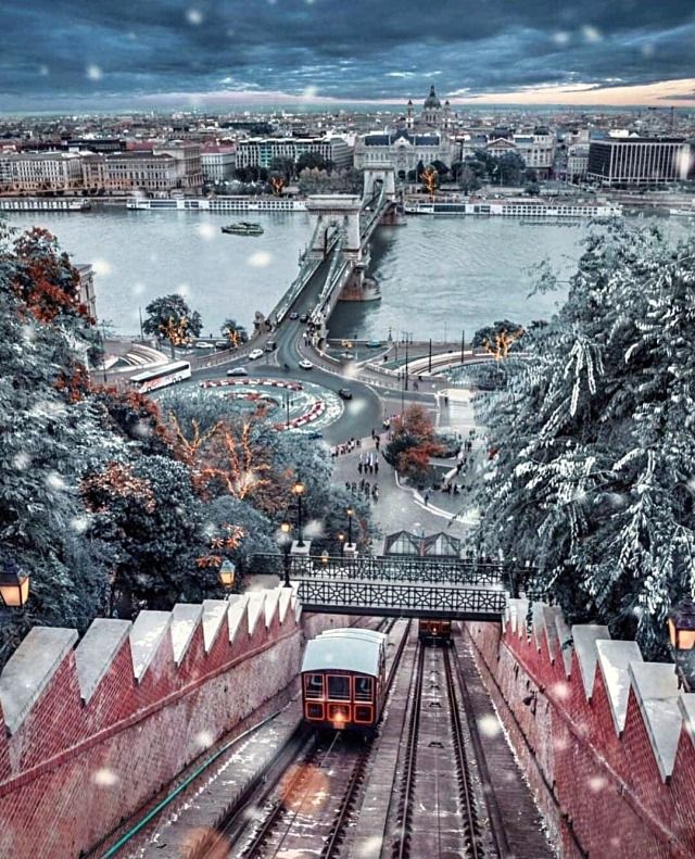 a train traveling down tracks next to snow covered trees