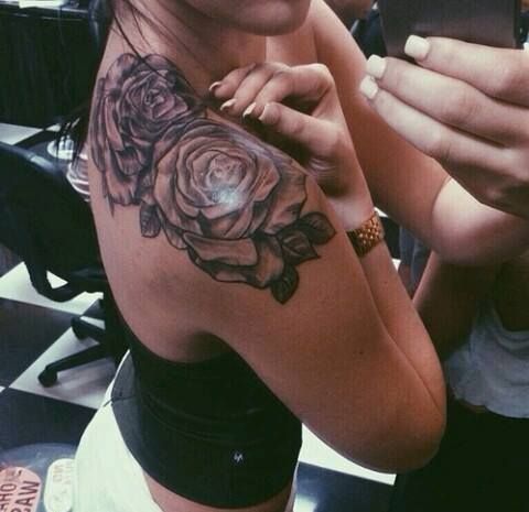 the back of a woman's arm with tattoos on it and an image of a rose