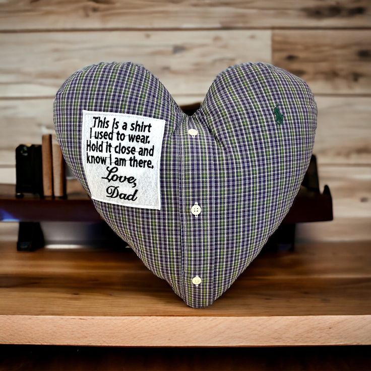 a heart shaped pillow sitting on top of a wooden table