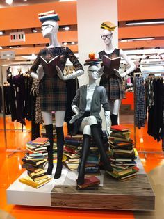 three mannequins dressed in kilts and dress clothes on display at a clothing store