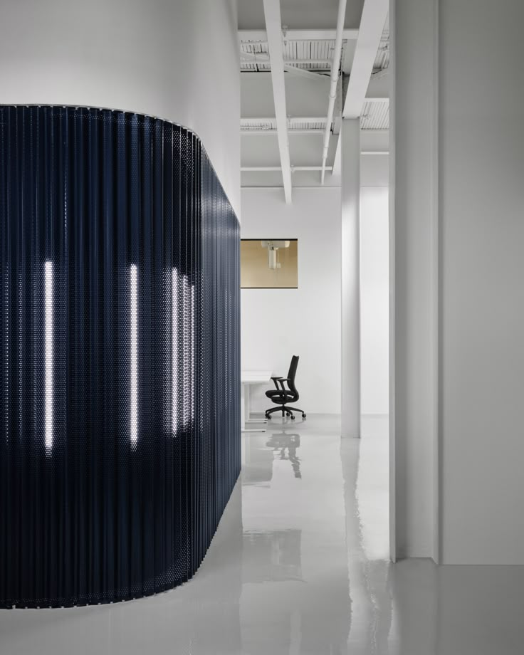 an office with white walls and black chairs