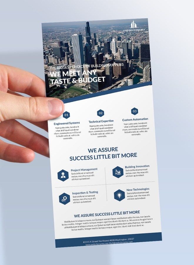 a person holding up a business brochure in front of a cityscape