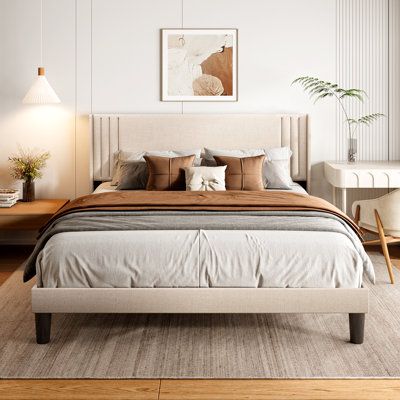 a bedroom with white walls and wooden floors