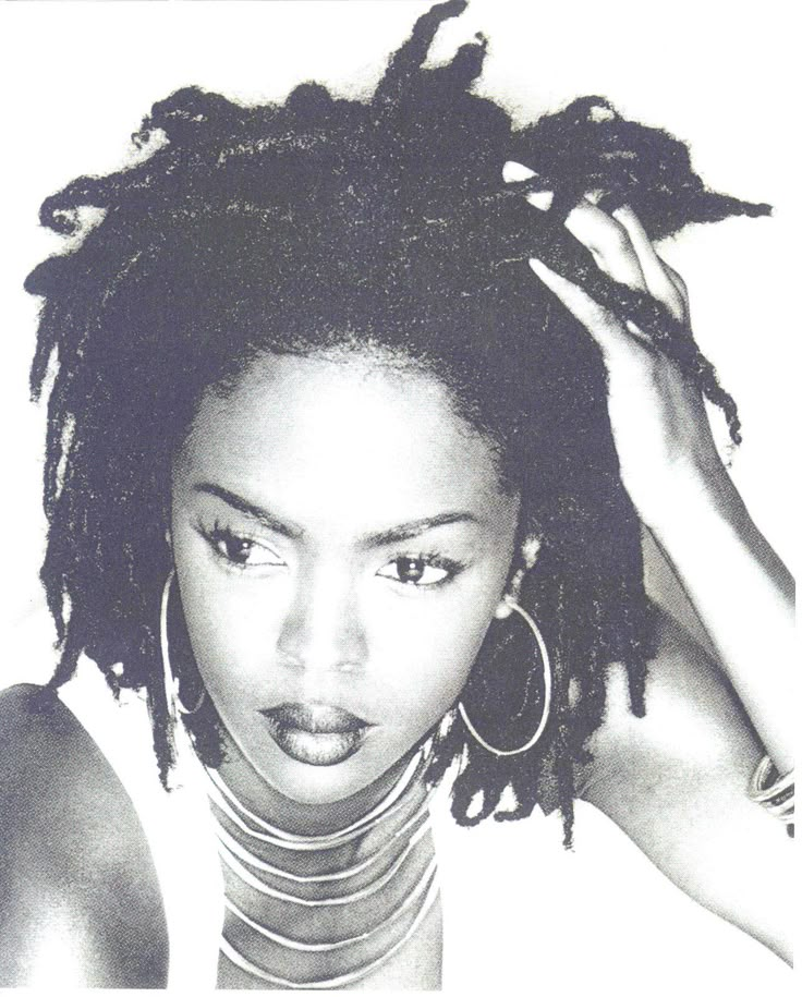 a black and white photo of a woman with dreadlocks