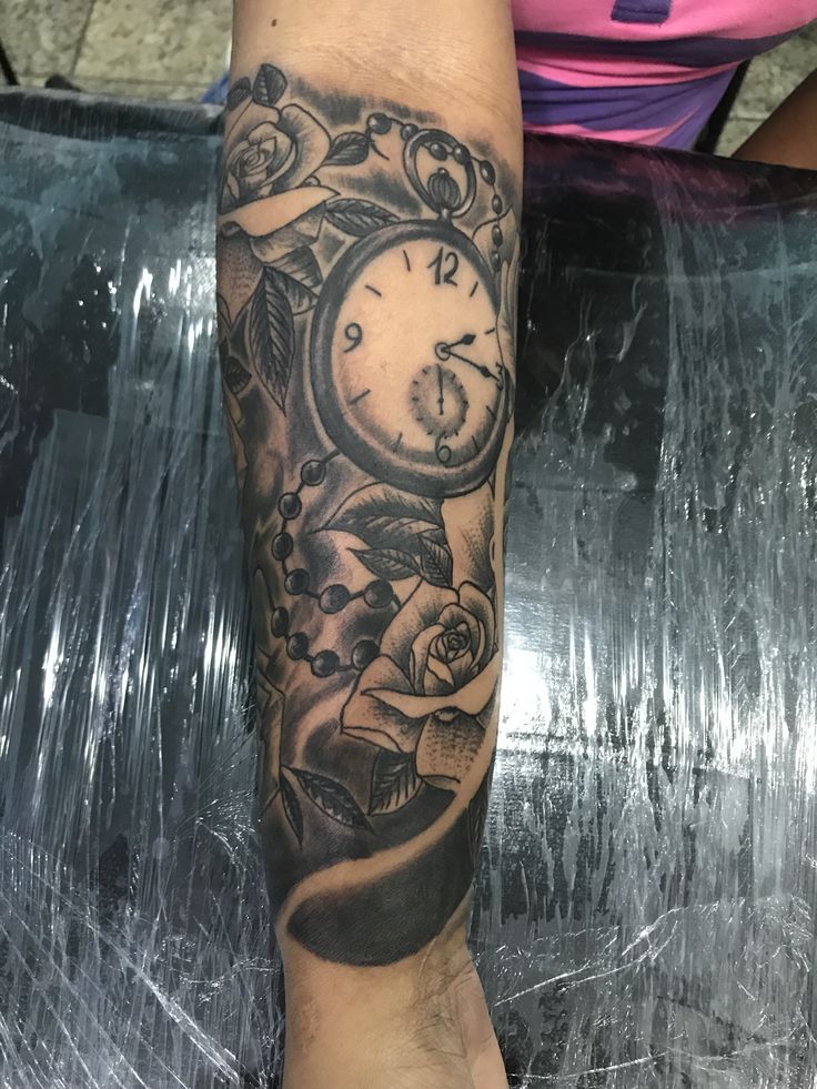 a person with a clock tattoo on their arm