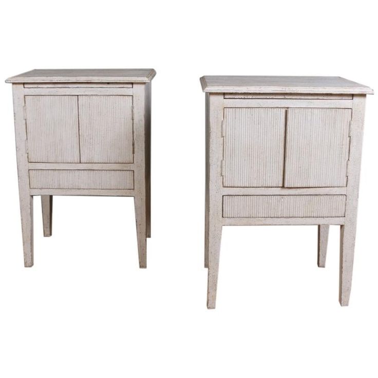 two white wooden nightstands side by side