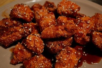 some food is sitting on a plate with sesame seeds