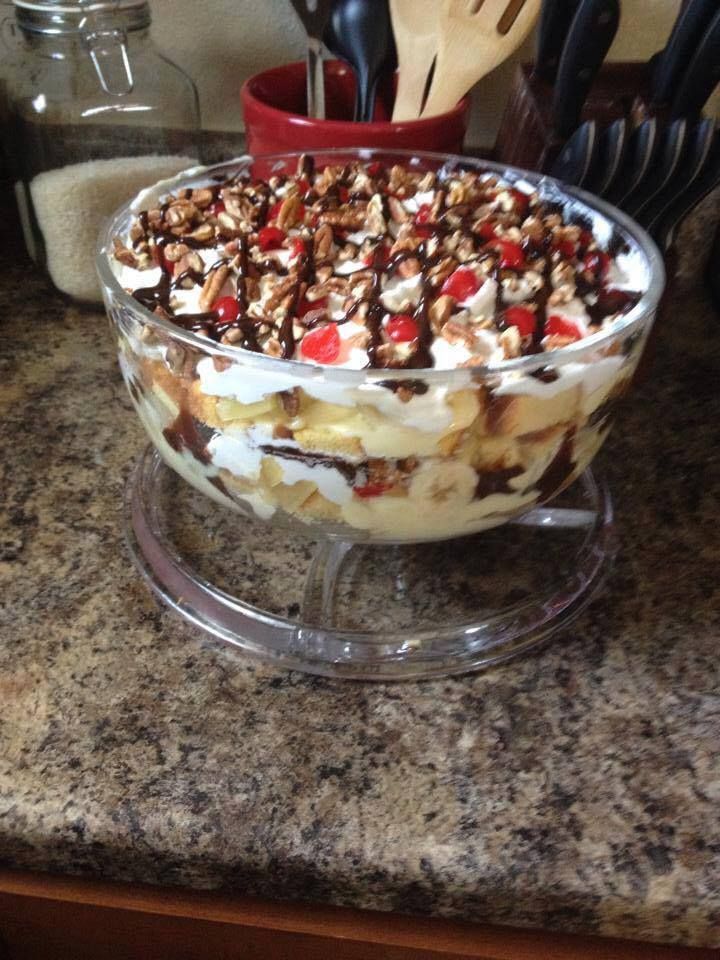 a dessert dish with fruit and nuts in it on a glass platter, ready to be eaten