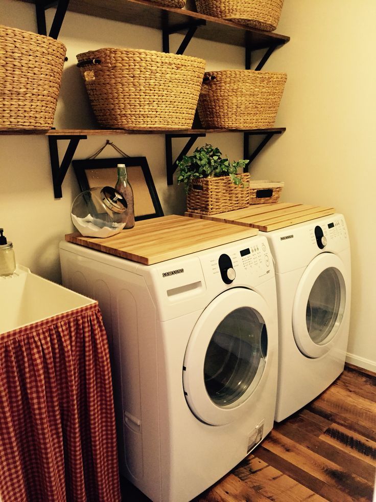 SMALL LAUNDRY. Decor to conceal drain and plug behind washer and dryer