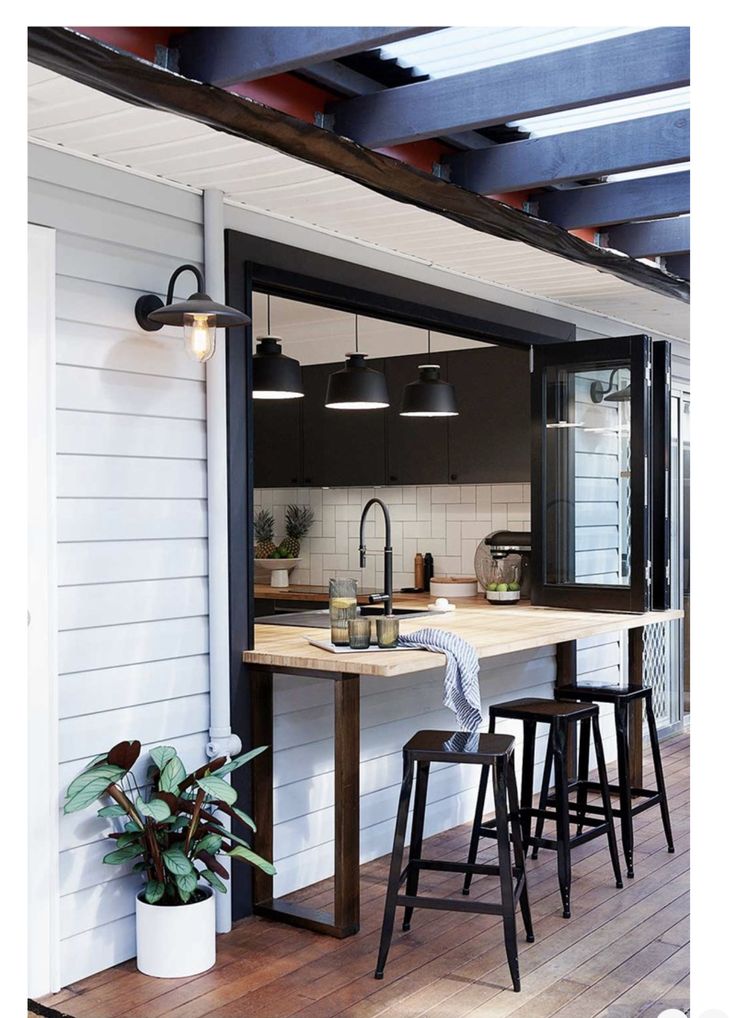 an open kitchen and dining area with stools in the foreground, on instagram