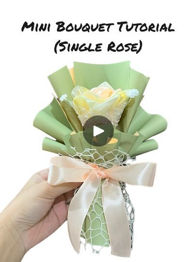 a person holding a bouquet with flowers in it and the words, mini bouquet floral single rose