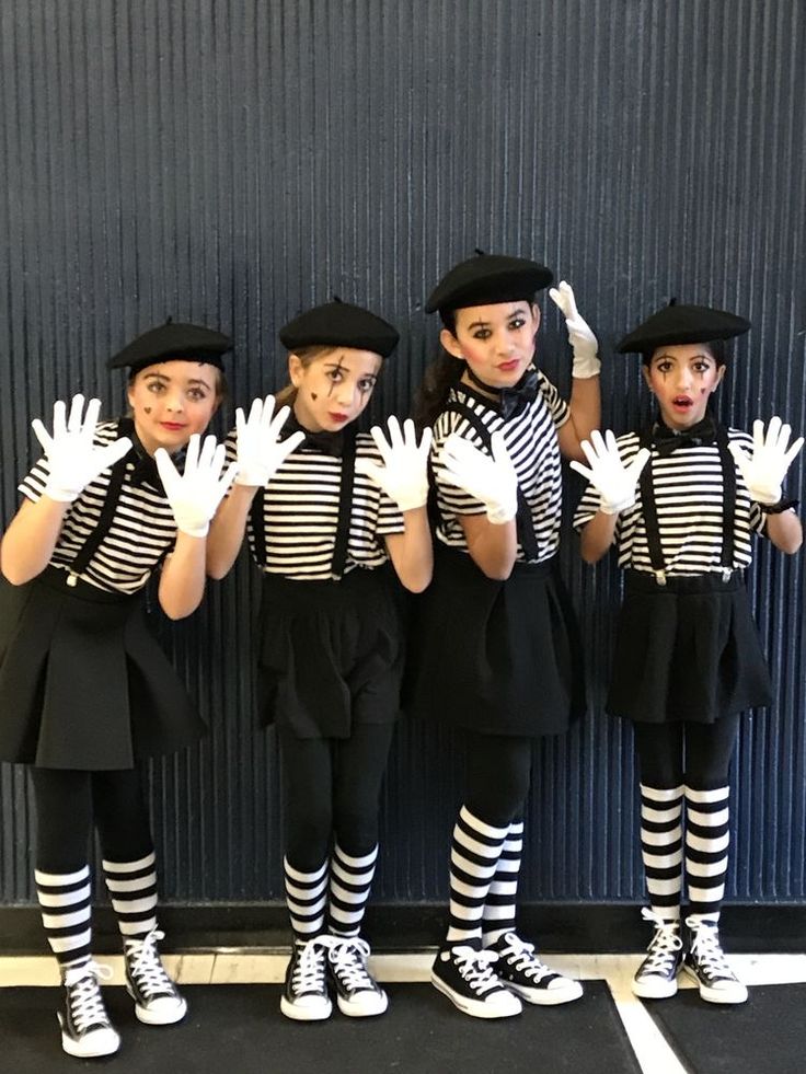 five children dressed in black and white striped outfits