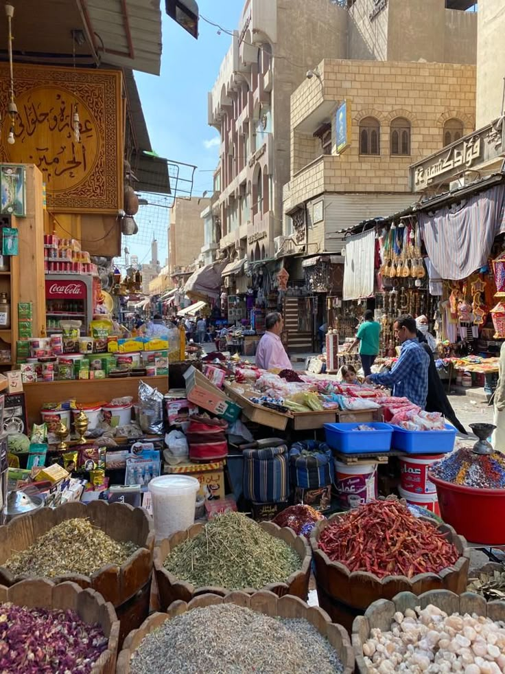 an outdoor market with lots of food on display