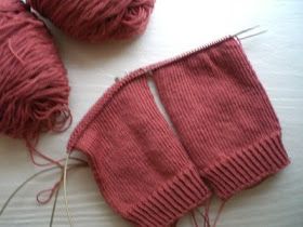 two balls of yarn sitting next to each other on top of a white tablecloth