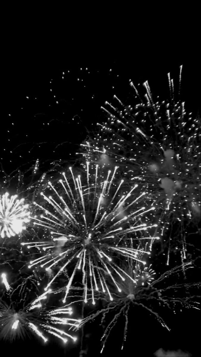 black and white fireworks in the night sky