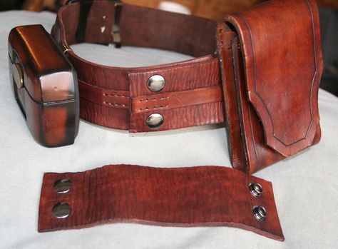 two pieces of leather sitting on top of a table