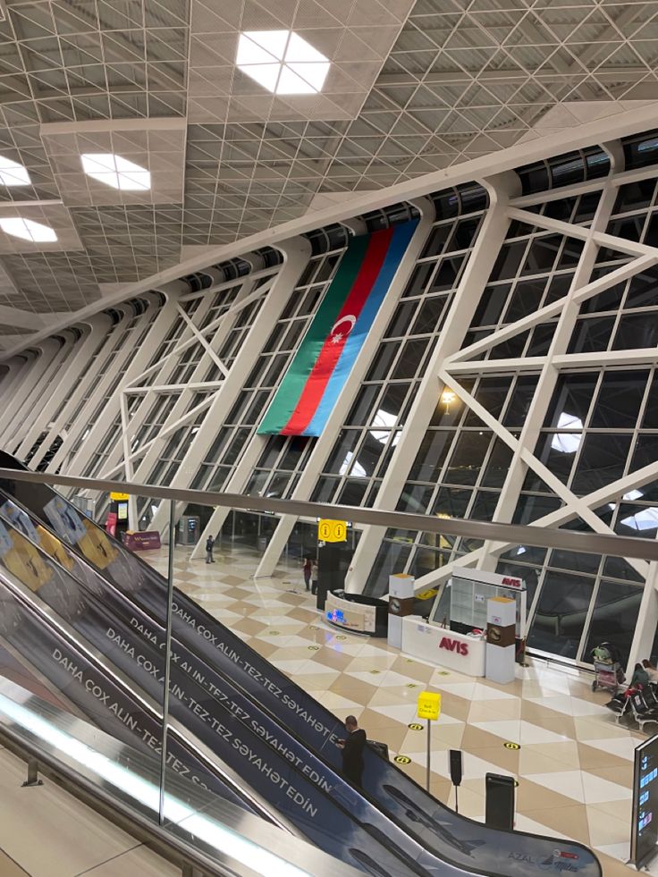 an escalator in the middle of a large building