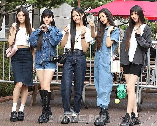 the girls are posing together in front of an umbrella