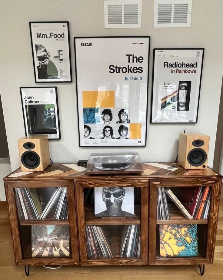 an entertainment center with record players and speakers