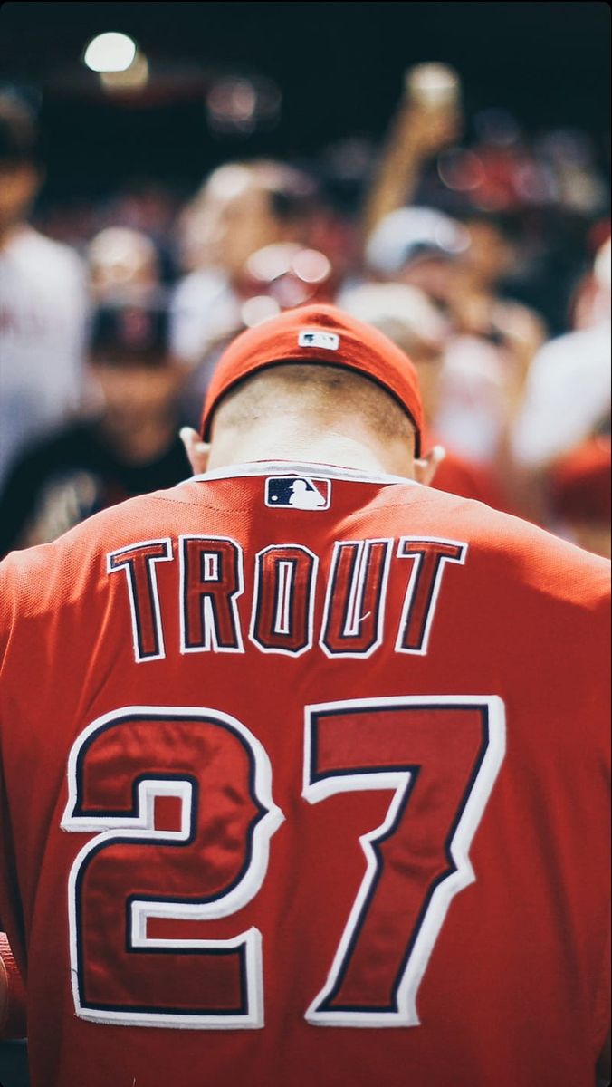 a baseball player wearing a red jersey with the number 27 on it's back