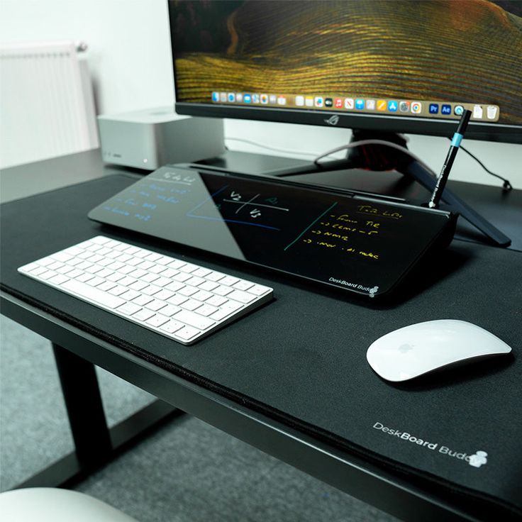 a desk with a keyboard, mouse and monitor on it