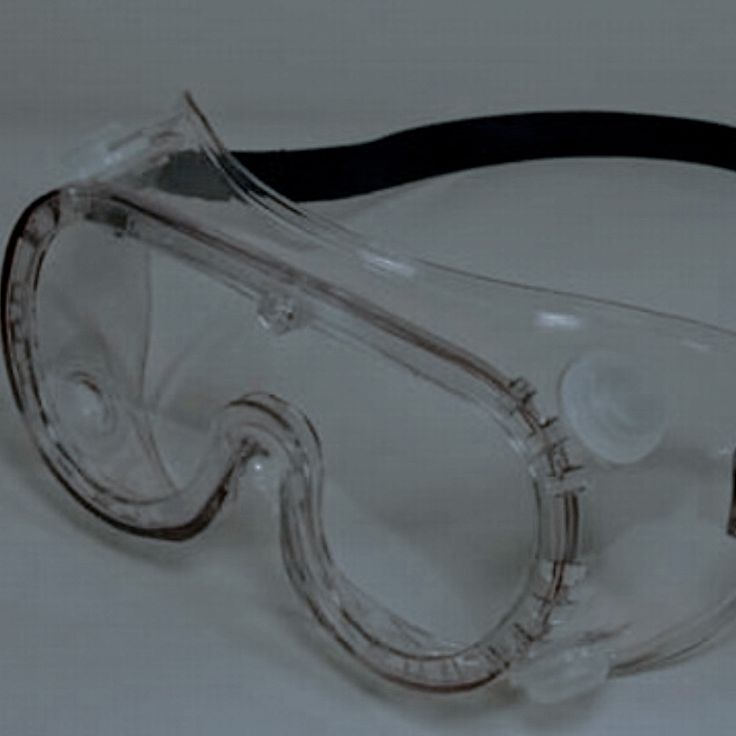 a pair of safety goggles sitting on top of a table