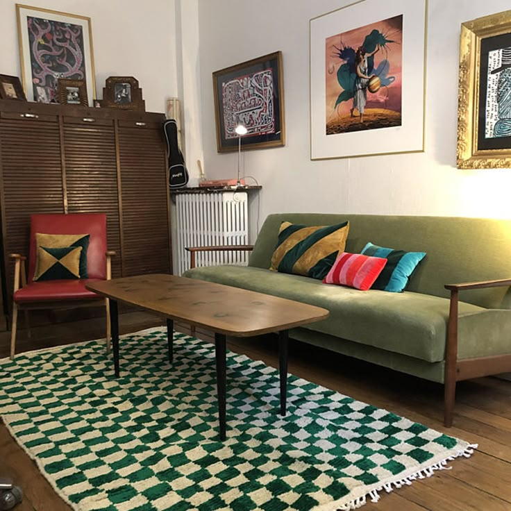 a living room filled with furniture and pictures on the wall