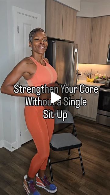 a woman in an orange top and leggings standing next to a chair with the words strength your core without a single sit - up