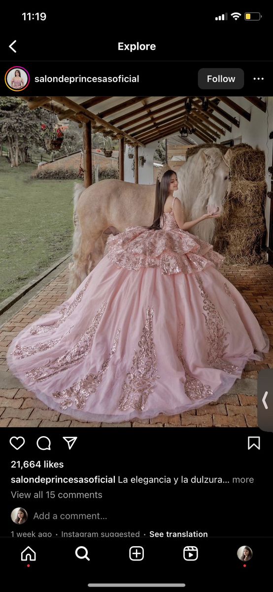 a woman in a pink dress standing next to a cow