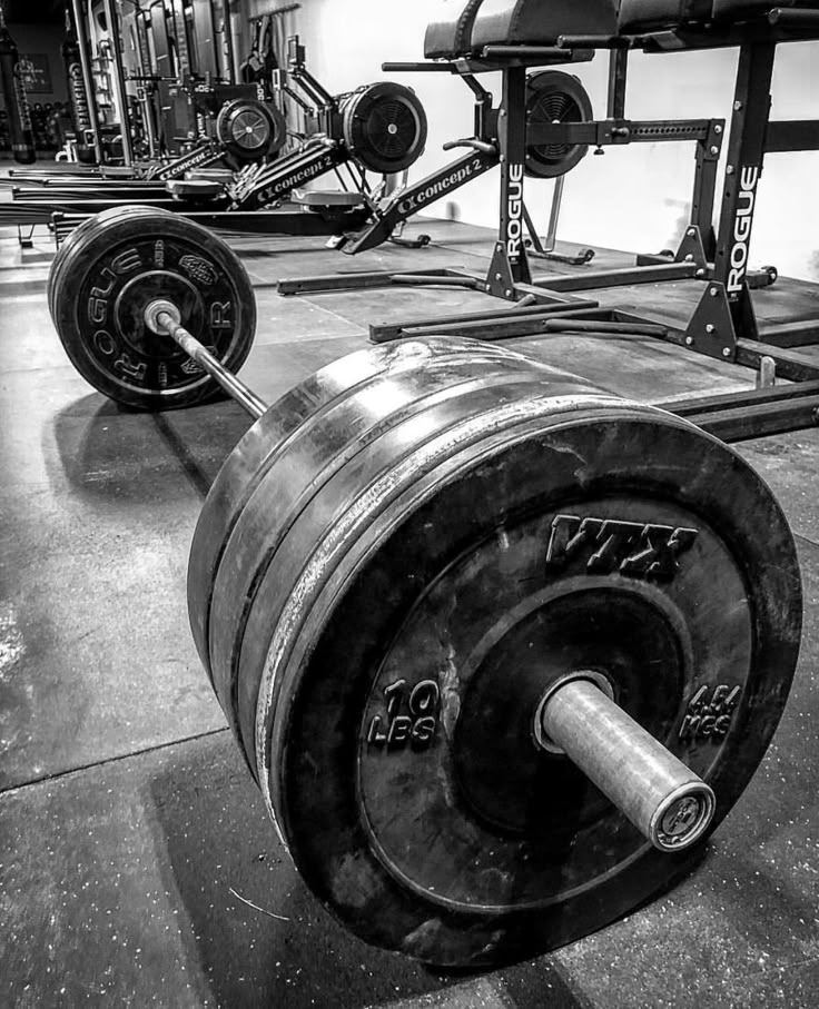 an image of a gym setting in black and white with dumbbells on the floor