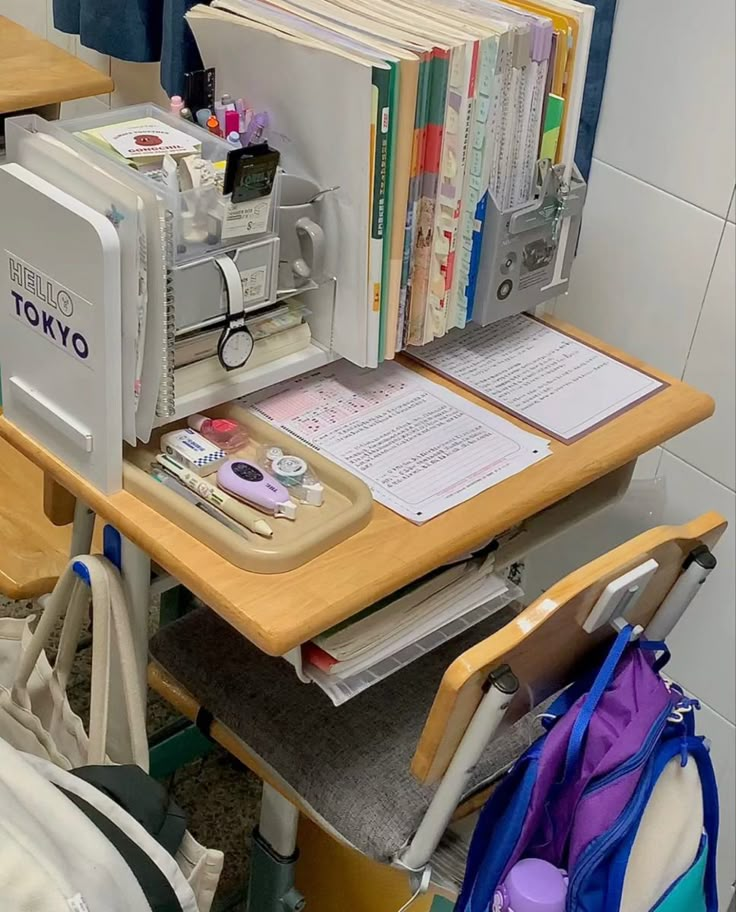 a sewing machine sitting on top of a wooden table next to a pile of books