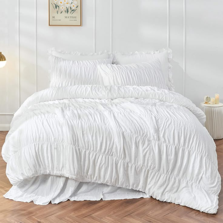 the comforter is white and has ruffled edges