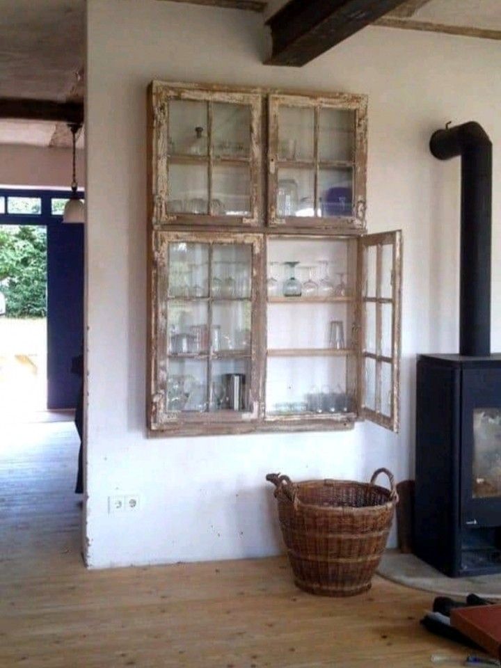 a living room with an old fashioned wood stove and window panes on the wall