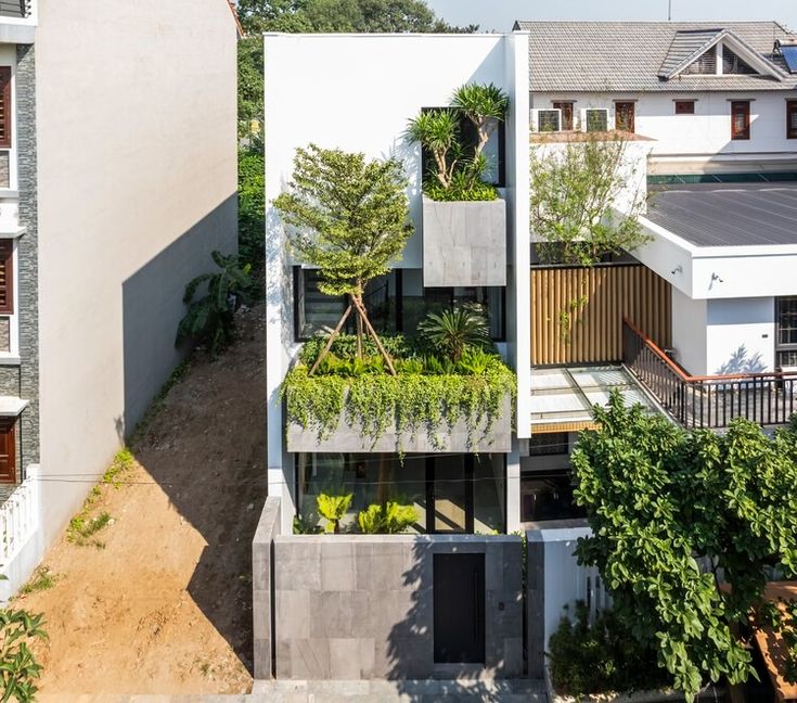 an aerial view of a building with plants growing on the side and in the middle