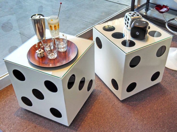 two dice shaped tables with drinks on them