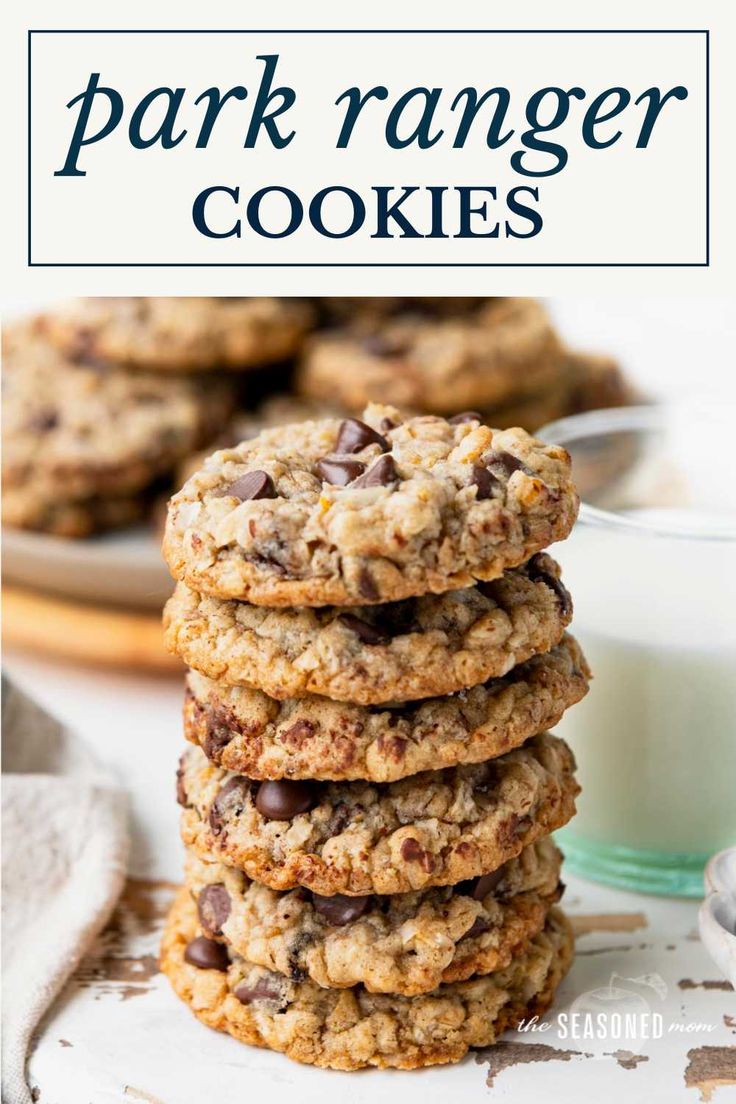 cookies stacked on top of each other with chocolate chips and oats in the background