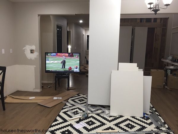 a living room filled with furniture and a flat screen tv sitting on top of a hard wood floor