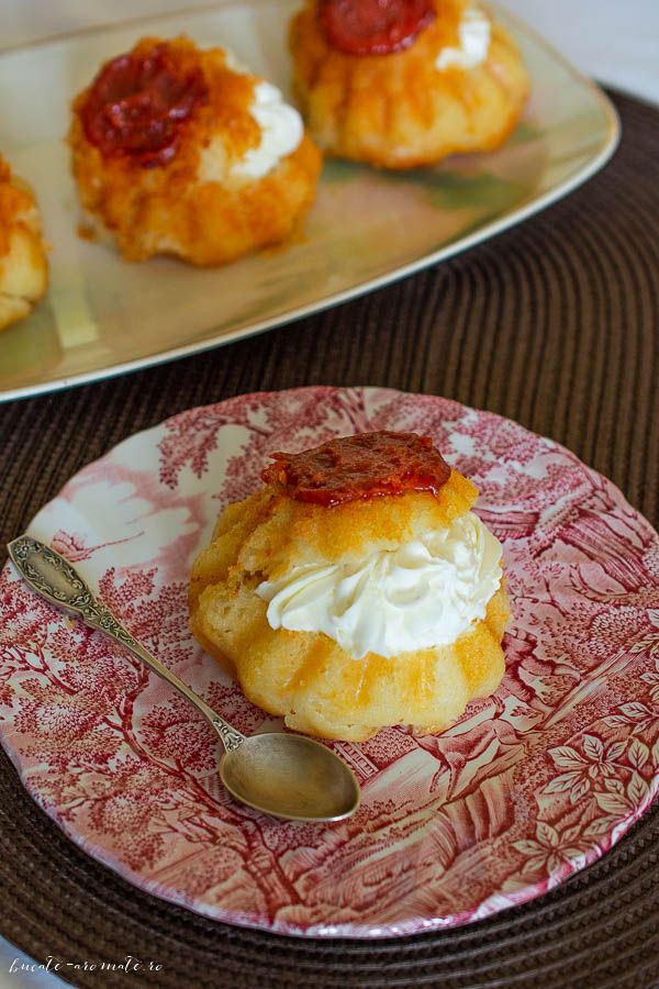 small pastries are sitting on plates with spoons