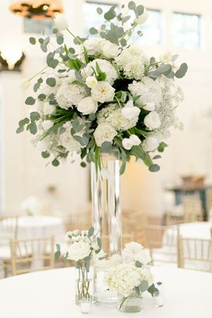 a vase filled with white flowers on top of a table