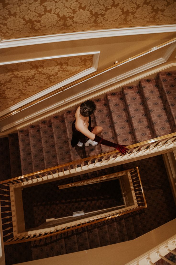 a man climbing up the stairs in a building