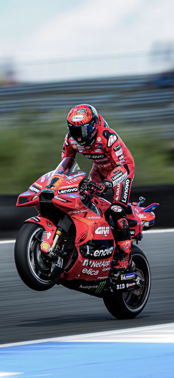 a person riding a motorcycle on a race track