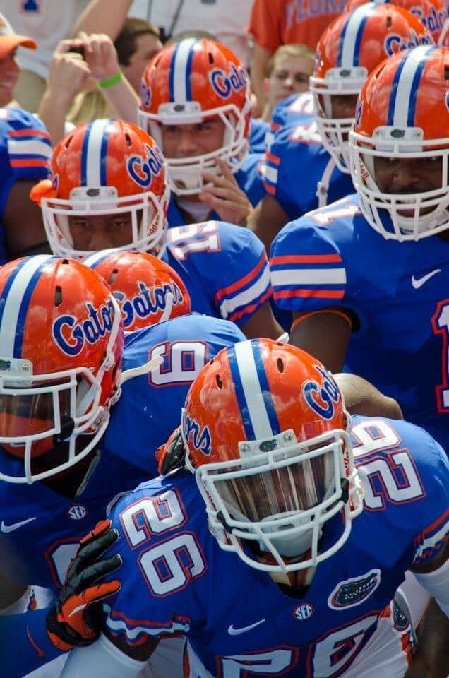 several football players in orange and blue uniforms