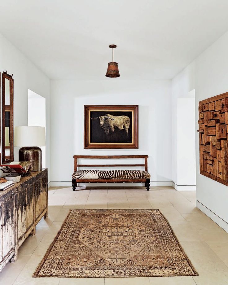 a living room filled with furniture and a painting on the wall